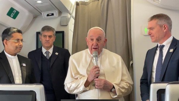 Pope prays for migrants in greetings to journalists on papal plane
